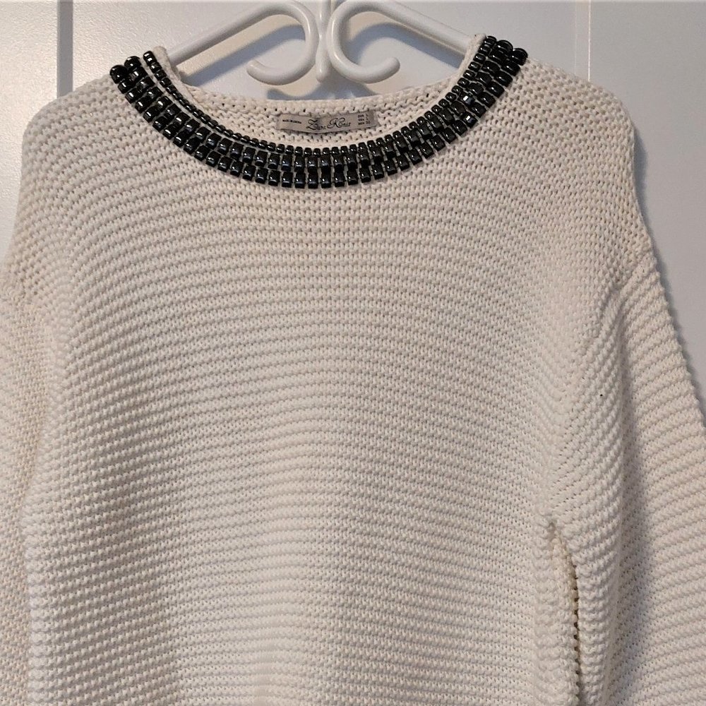 Elegant White Sweater with Embellished Neckline